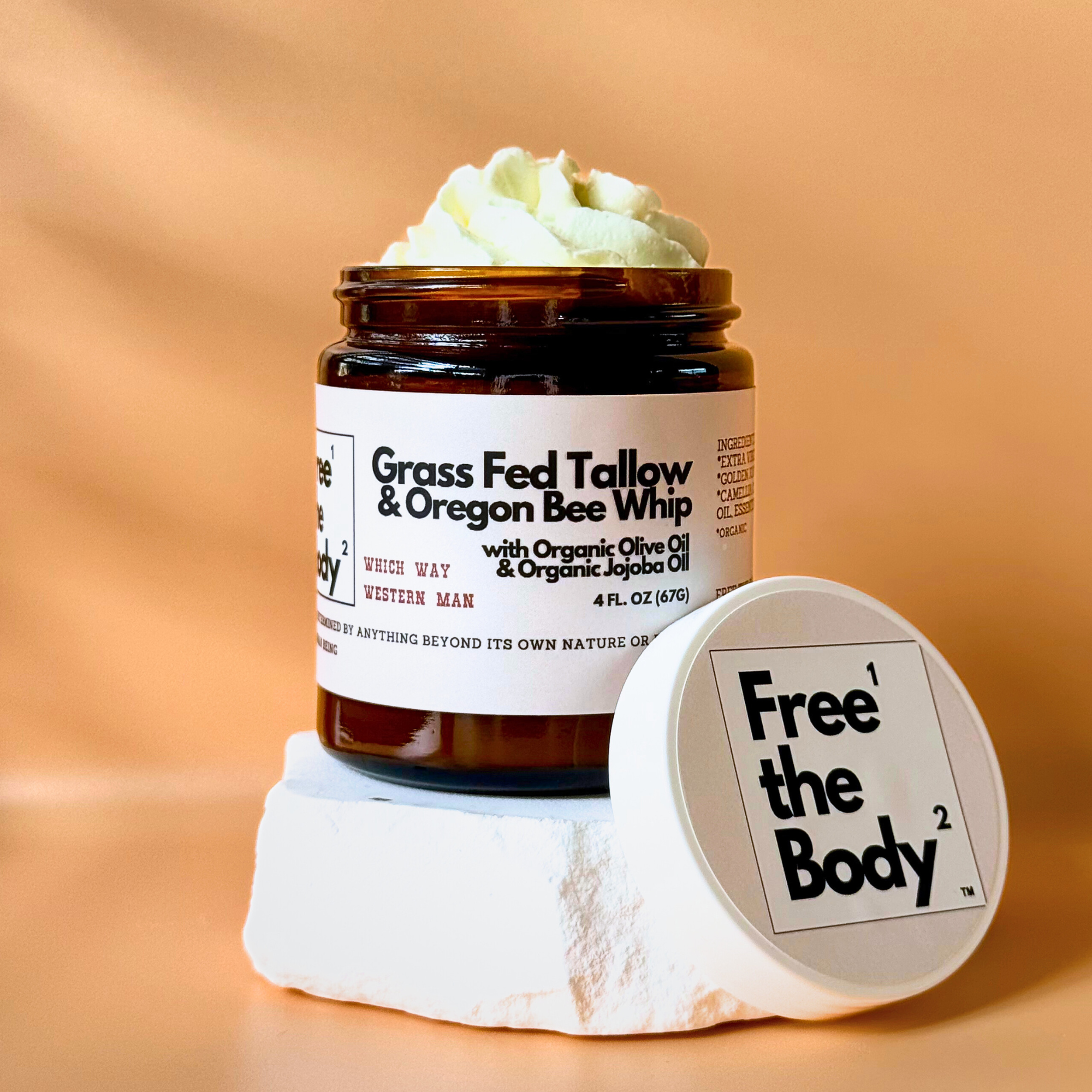 Jar of 'Free the Body' cream with a white lid on a beige background